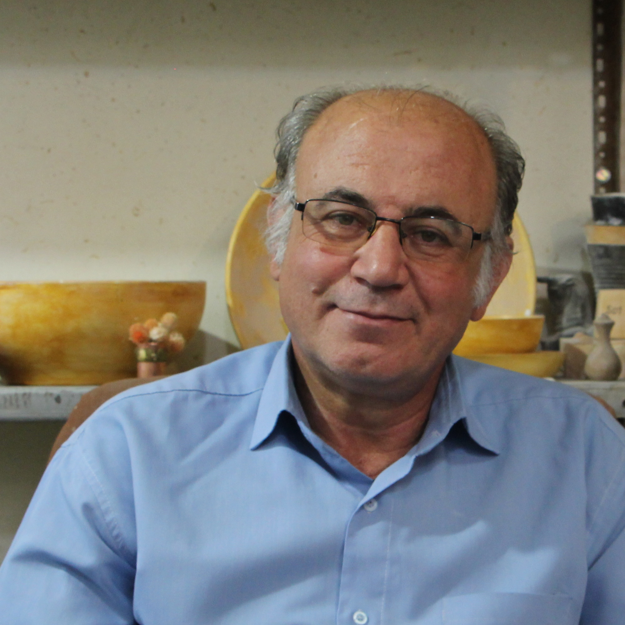 Soheil Shabany, experienced ceramist and educator, shaping ceramics at Pirouchak Art Studio